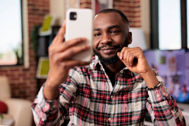 istock Male freelancer taking photos on smartphone 1420726998