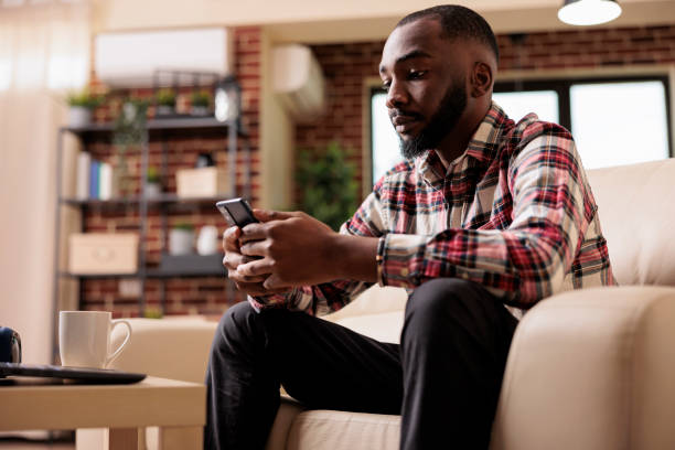 istock Young adult browsing internet on smartphone 1420727758