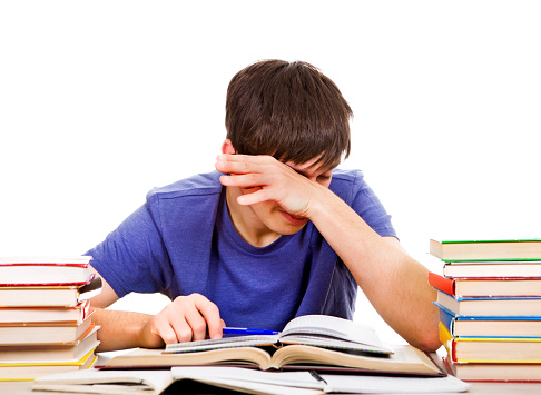 Tired Student Rub an Eyes on the School Desk Isolated on the White Background