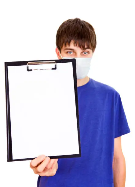 Young Man in Flu Mask showing empty Clipboard on the White Background