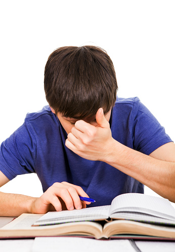 Tired Student Rub an Eyes on the School Desk Isolated on the White Background