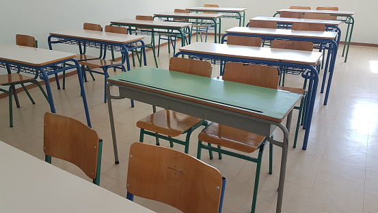 desks class chairs in secondary school empty in the morning