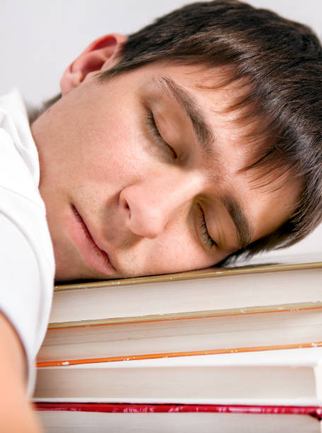 istock Young Man sleep with a Books 1420734157