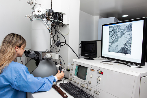 Adult Female Researcher Working With Powerful High Frequency Laser used for new materials research.