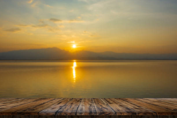 istock Empty wooden table on beautiful lake sunset 1420735964