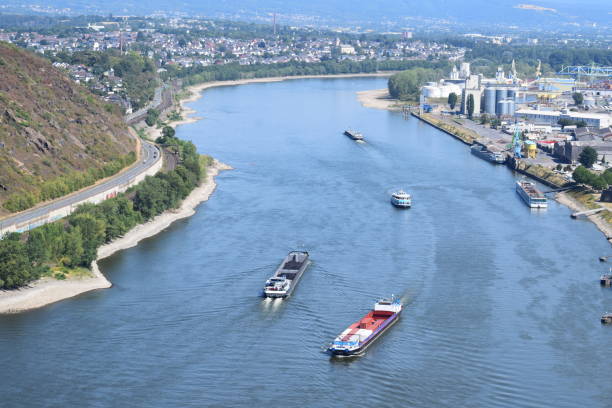 Large barges carrying cargo on the river rhine in Germany.