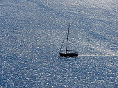 Aerial view of sailboat sailing on opensea on a sunny day in Izmir Cesme