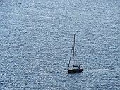 Aerial view of sailboat sailing on opensea on a sunny day in Izmir Cesme