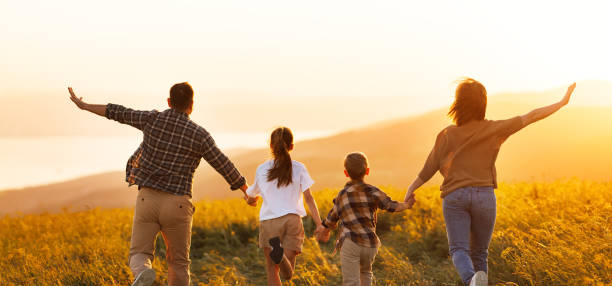 istock Happy family: mother, father, children son and daughter on sunset 1420739792