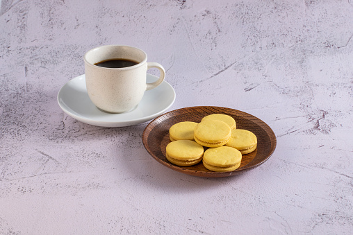 Coffee and stuffed cookies on a separate plate on gray background