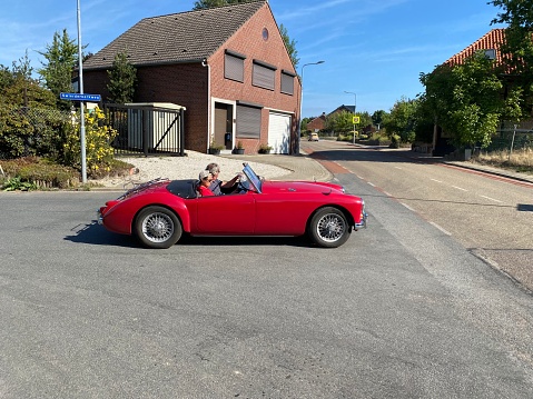Hulsberg, Netherlands - September 04, 2022.  MG classic sports car on the road during route of  collector cars in  the country.