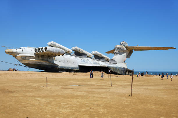 Dagestan, Russia - 25 July, 2022: Tourists walking around the abandoned Soviet Lun-class ekranoplan on the coast of the Caspian Sea