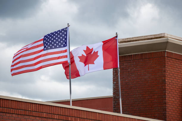 istock American and Canadian Flags and a  brick building 1420747556