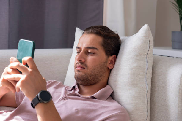 istock Young man lying down and surfing the internet 1420748716