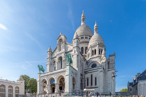 General view of the Basilica of the Sacred Heart of Paris (Basilica Sacred Coeur) at the top of Montmartre in Paris, France. It is the second place most visited by tourists in Paris.