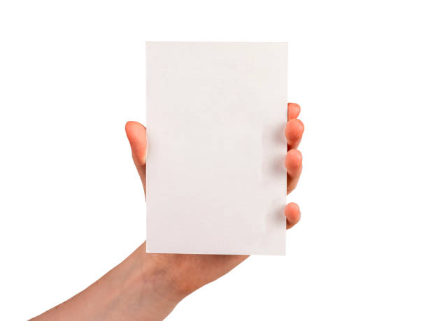 istock Hand holding postcard mockup isolated on white background. Template for congratulation, invitation, note. Paper in vertical position. 1420750829