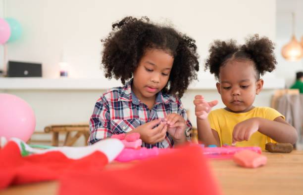 istock Two little girls Playing with plasticine 1420751430