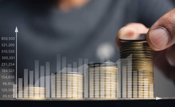 istock Men are putting coin on stack save money and put coin in glass jar with graph. 1420751504