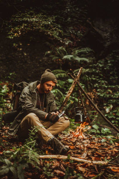 istock young man doing bushcraft in the forest 1420752948