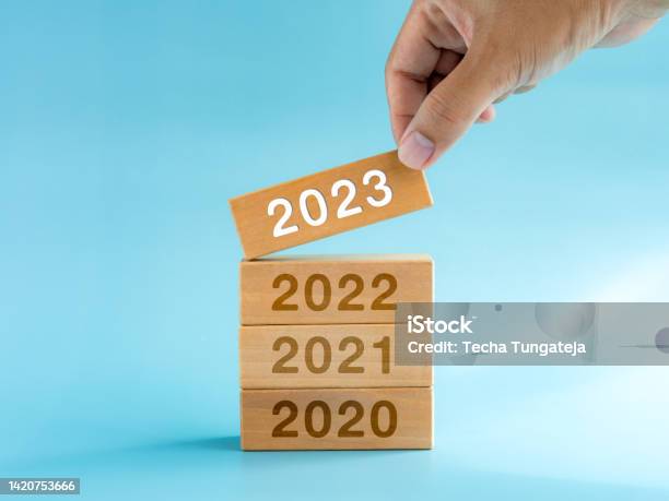 2023 Happy New Year Background 2023 Calendar Numbers On Wooden Cube Blocks Stacked Building By Hand Isolated On Blue Background Business Planning Trends Goal Success And Vision Concepts Stock Photo - Download Image Now