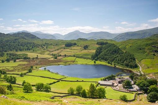 Watendlath Tarn lies in fields in the mountains of Cumbria, English Lake District