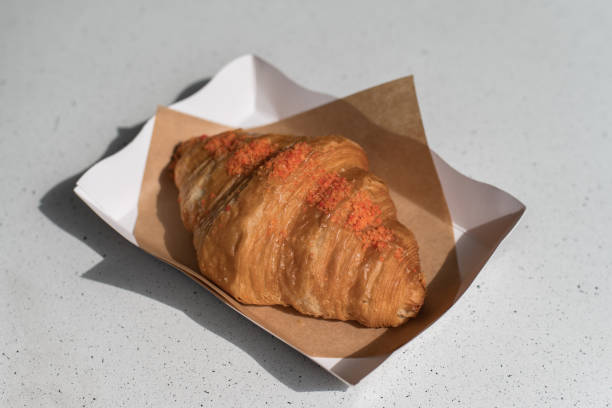 Fresh croissant served in white paper plate stock photo