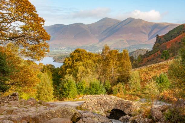 istock Ancient stone road bridge with autumn trees and mountains in the background 1420758464