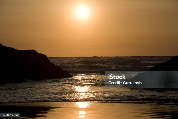 Sun Setting With A Golden Glow And Reflections Of Light Of The Sea Stock Photo - Download Image Now