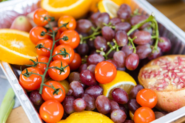 istock Small tomatoes, pomegranates, oranges, grapes, healthy life 1420760295