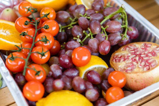 istock Small tomatoes, pomegranates, oranges, grapes, healthy life 1420760334