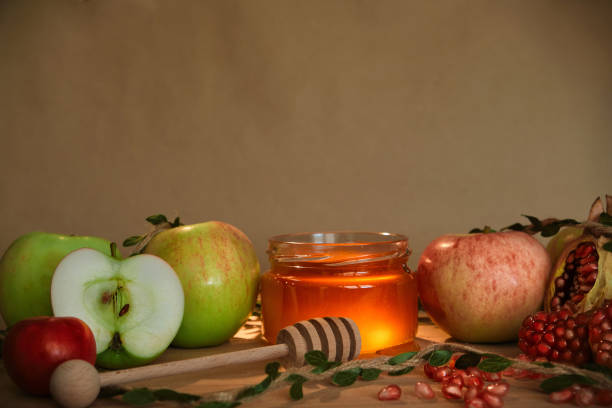 Apples, pomegranate and honey, the traditional food of the Jewish New Year - Rosh Hashana. Copy space background Apples, pomegranate and honey, the traditional food of the Jewish New Year - Rosh Hashana. Copy space background orthodox judaism photos stock pictures, royalty-free photos & images