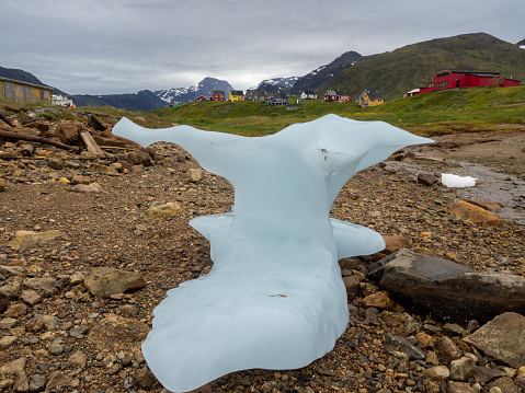 Stranded iceberg on the shores of the port settlement of Narsaq, Southern Greenland