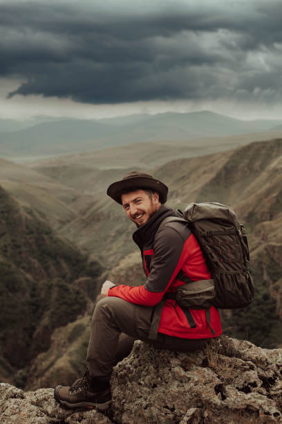 istock mountaineer young man climbing in mountains 1420764994