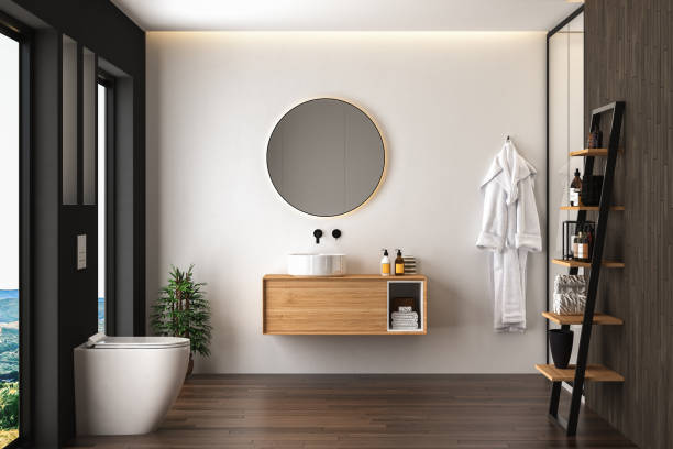 Bathroom interior with dark parquet, toilet, shower and oval mirror, white and black walls front view. Minimalist black bathroom with modern furniture. 3d rendering stock photo