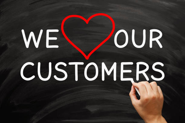 Customer Appreciation And Satisfaction Concept On Blackboard Hand writing We Love Our Customers on blackboard. Customer appreciation and satisfaction concept. customer retention stock pictures, royalty-free photos & images