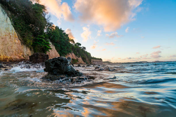 Waves breaking in the stones at Pipa Beach at sunset time