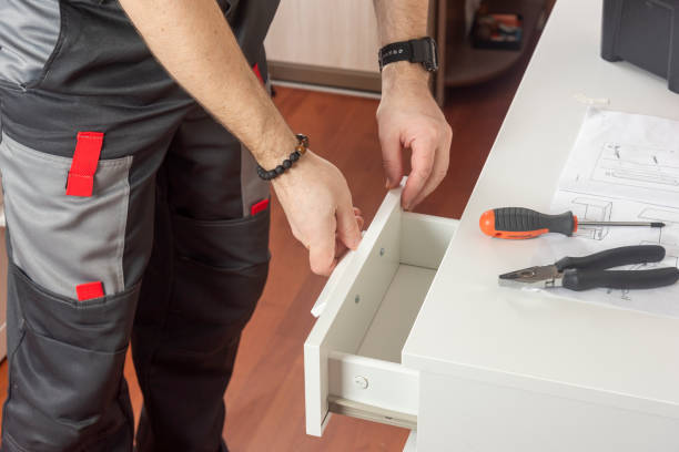istock a male furniture assembler is engaged in assembling a desk with a bedside table 1420769006