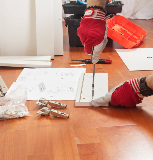istock a man is assembling furniture in a new apartment 1420769460