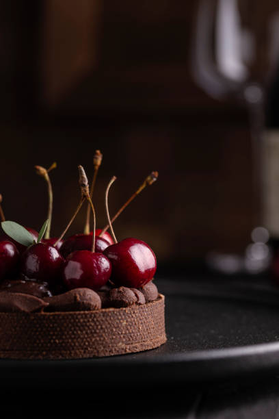 istock Chocolate tart with ganache decorated with cherry 1420770096