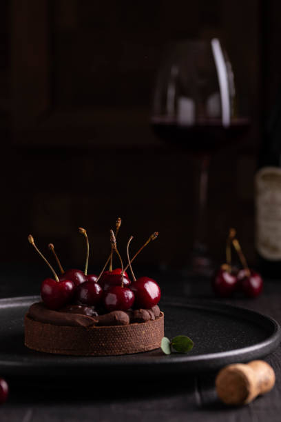 istock Chocolate tart with ganache decorated with cherry 1420770148