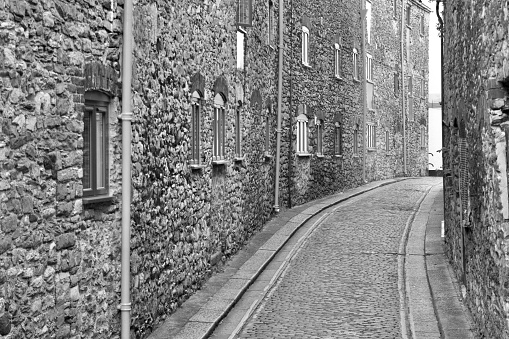 Monochrome image of architectural details of the narrow cobbled streets in the heart of the Barbican, Plymouth, Devon, England. An area of historic importance and ancient maritime heritage.
