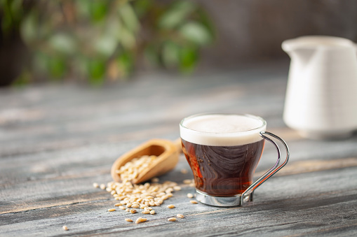 Cup with coffee barley with barley grains. Healthy herbal drink for immunity. Coffee alternatives