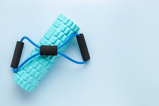 Fitness workout or yoga equipment. Massage foam roller and expander. Top view. Sport  concept. Flat lay. Copy space