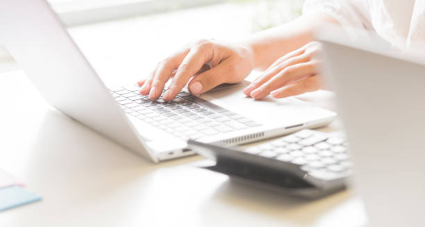 istock female hands use a laptop in the office. 1420776107