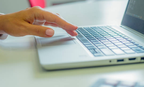 istock female hands use a laptop in the office. 1420776110
