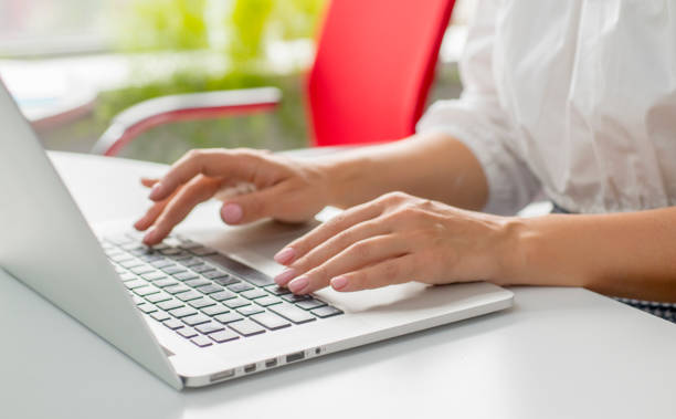 istock female hands use a laptop in the office. 1420776137