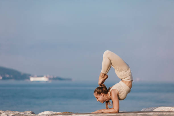 istock Lady doing yoga at seaside 1420776507