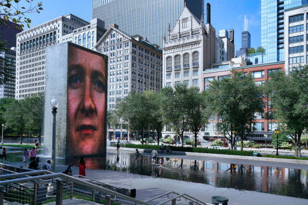 The Crown Fountain in Millennium Park Chicago, USA - August 29, 2022: The Crown Fountain in Millennium Park on Michigan Avenue, has an LED screen that shows the faces of thousands of Chicago residents who volunteered millennium park stock pictures, royalty-free photos & images