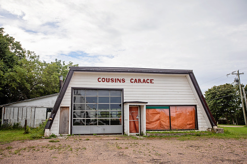 Malpeque, Canada - August 23, 2022. An out-of-service auto repair business facade in rural Prince Edward Island.