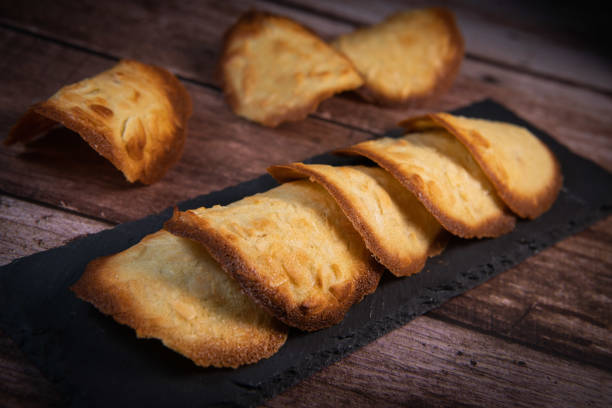 French delicacy pastry tuile with almond on wood background French delicacy pastry tuile with almond on wood background, High quality photo tolosa stock pictures, royalty-free photos & images
